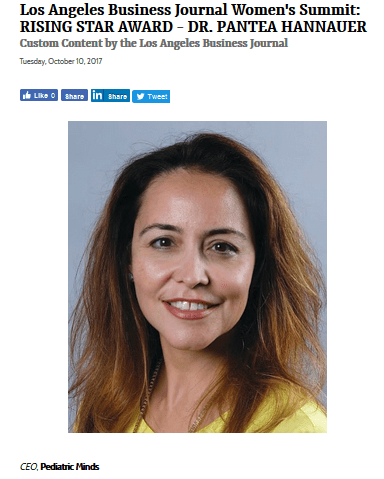 Professional headshot of a smiling woman with long hair in a yellow top.